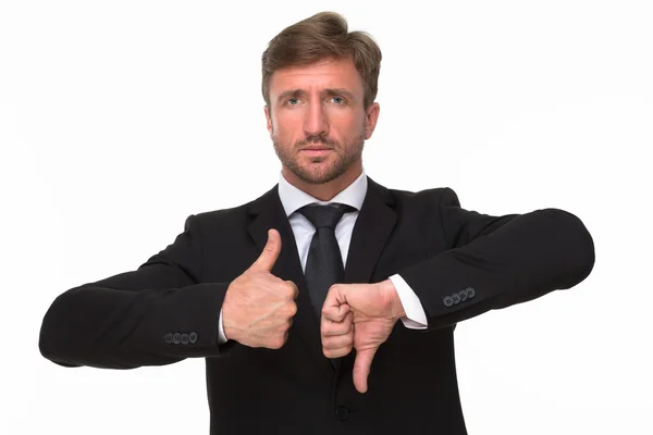 Businessman hands giving a thumbs up and down — Stockfoto