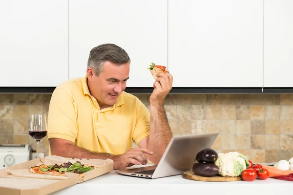 Mature homme avec ordinateur portable dans la cuisine — Photo