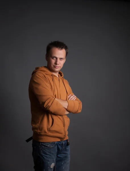 Serious young man with his arms folded — ストック写真