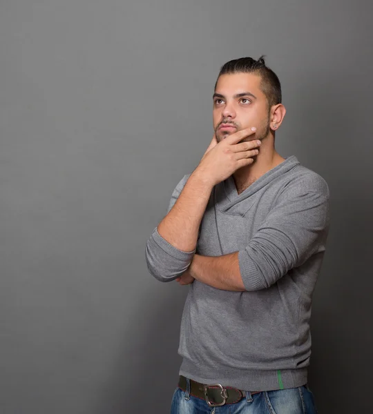 Thoughtful fashionable hipster man in studio — Stock Photo, Image