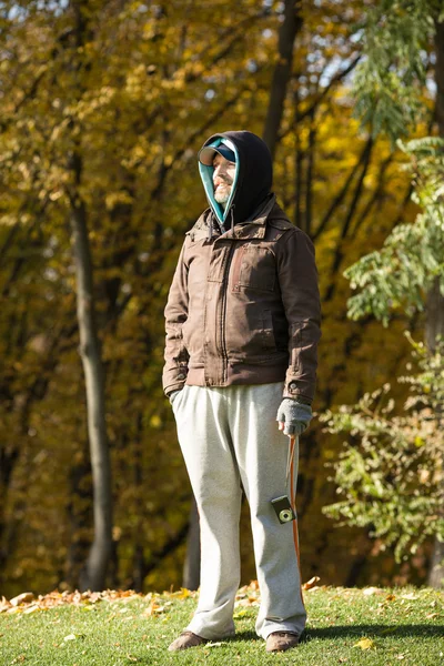 Handsome man in sports costume standing in the park
