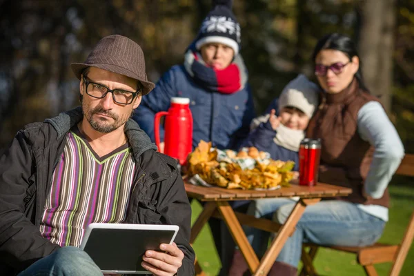 Father working on a picnic with his tablet PC — Stock Fotó