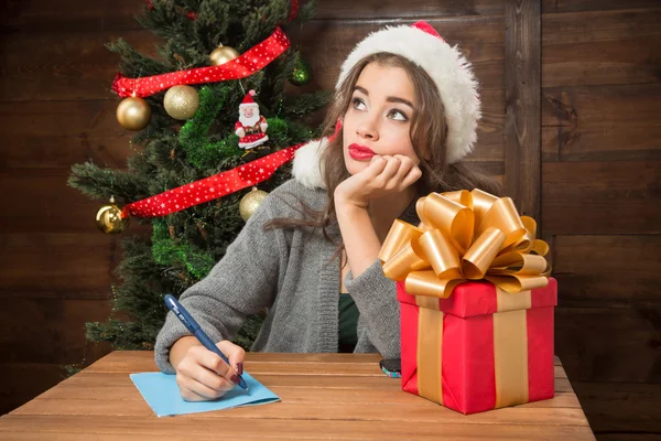 Beautiful girl thinking about New Year and Christmas congratulation — Stock Photo, Image