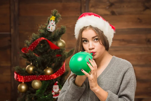 Beautiful girl blowing a baloon — Stock Photo, Image