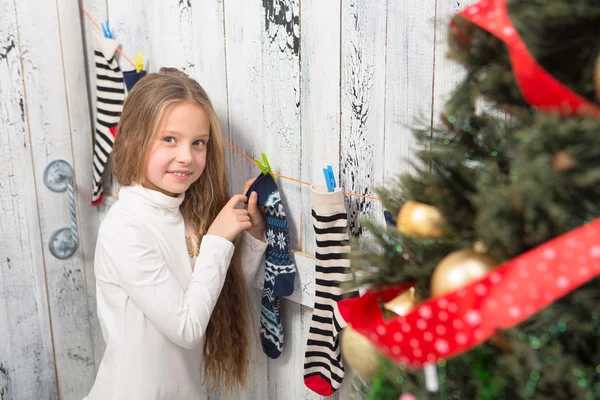 Teenage girl looking  Christmas socks — Stock Photo, Image