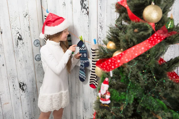 Teenage girl looking into  Christmas socks — Stock Photo, Image
