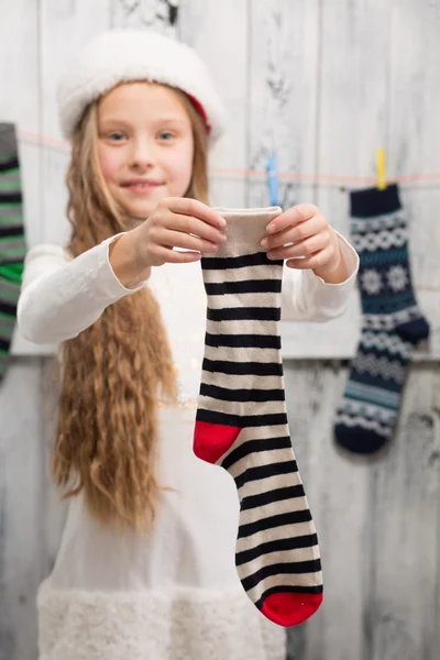 Teenage girl showing  Christmas socks — Stock Photo, Image