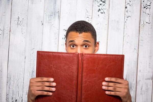 Handsome man hiding behind register — Stock Photo, Image