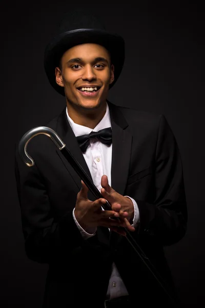 Handsome man in top hat posing with cane — Stock Photo, Image