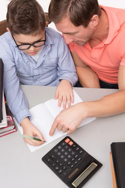 Close-up of father and son sitting at the table — Stockfoto