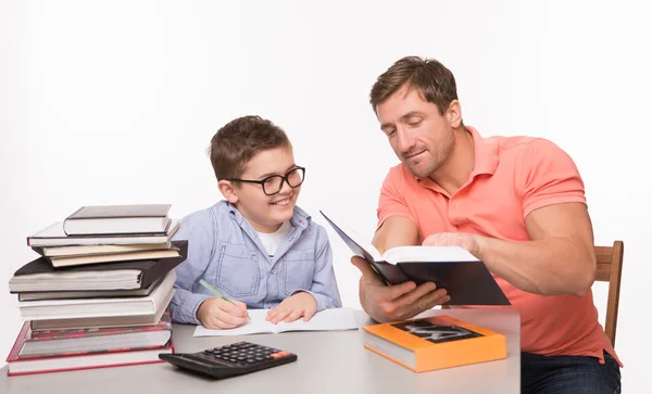 Boy doing homework together with his father — Stock Photo, Image