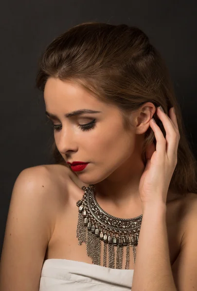 Beautiful lady posing with necklace in studio — Stock Photo, Image