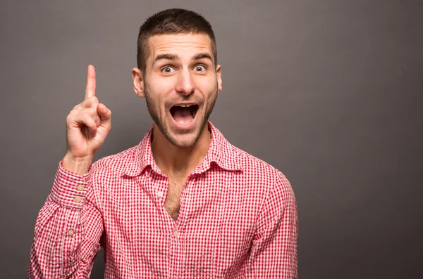 Handsome young man pointing up — Stock Photo, Image