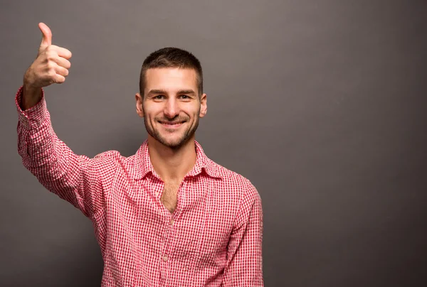 Handsome man showing thumb-up — Stock Photo, Image