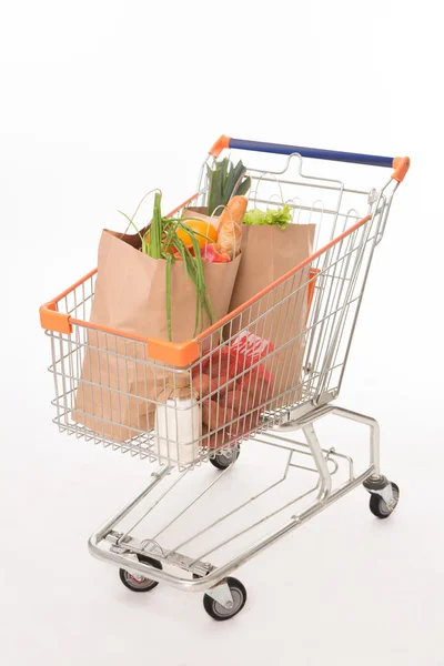 Shopping cart with shopping bags — Stock Photo, Image
