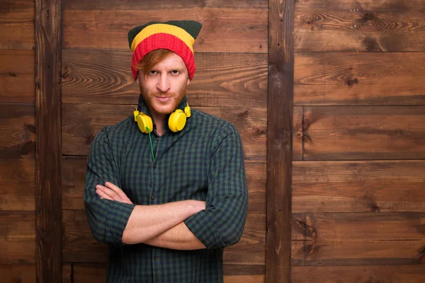 Hipster man in hat over wooden — Stock Photo, Image