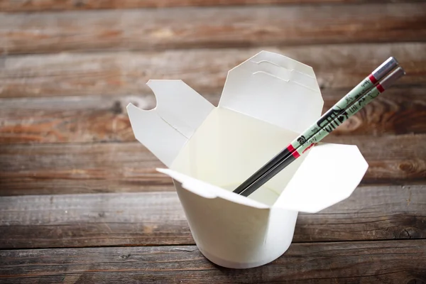 Blank Chinese food container on old wood table — Stock Photo, Image