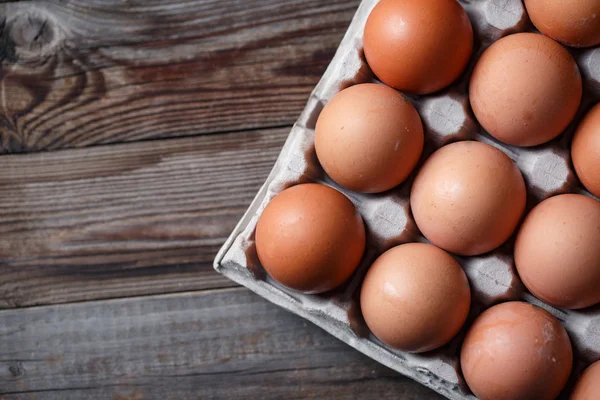 Brown eggs on a rustic wooden table — Stock Photo, Image