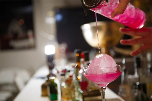 Close-up barman ruční lití růžové koktejlové nápoje v baru — Stock fotografie