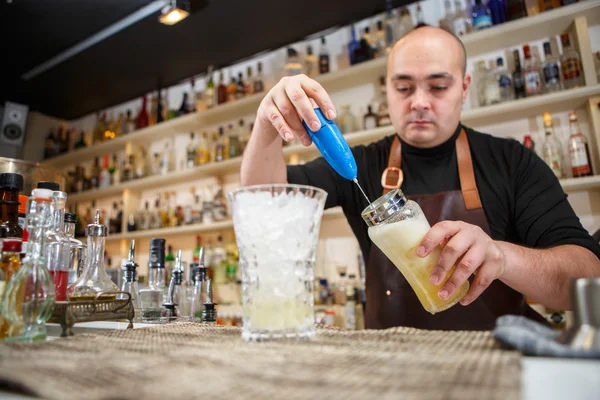 Barman pomocí ruční mixér připravit nápoj v baru nebo v hospodě — Stock fotografie