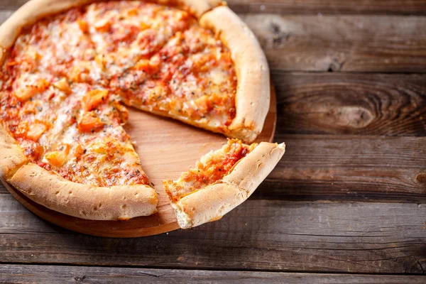 Delicious italian pizza with one eating piece — Stock Photo, Image