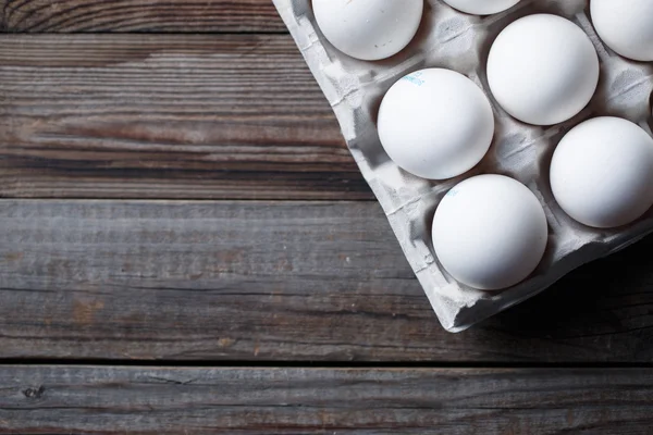 White eggs on a rustic wooden table — Stock Photo, Image