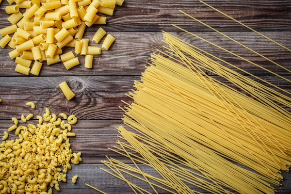 Закрыть портрет сырой домашней итальянской пасты, макарон, спагетти и феттучини — стоковое фото