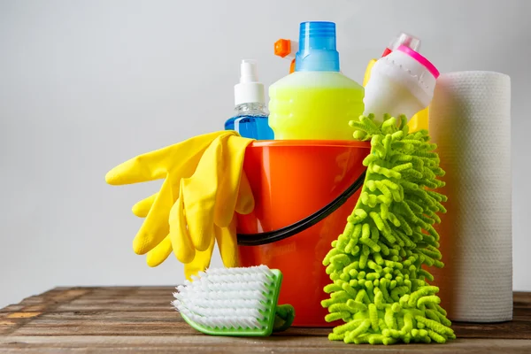 Bucket with cleaning items on light background — Stock Photo, Image