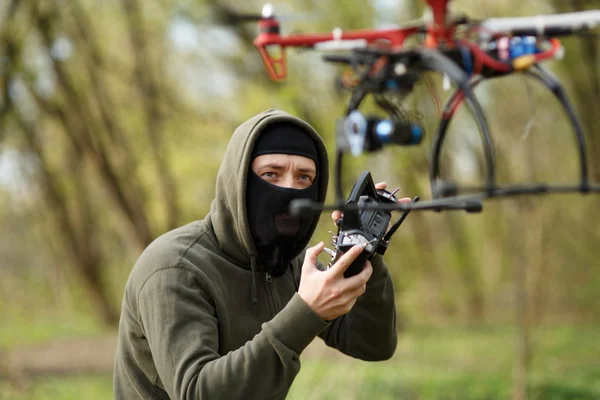 리모 콘으로 드론을 조종하는 마스크를 쓴 남자. — 스톡 사진
