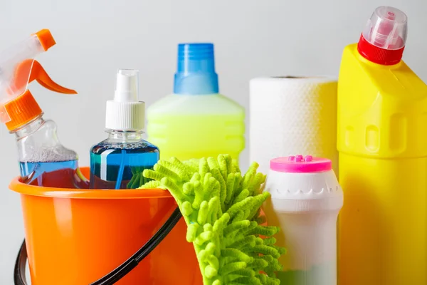 Bucket with cleaning items on light background — Stock Photo, Image