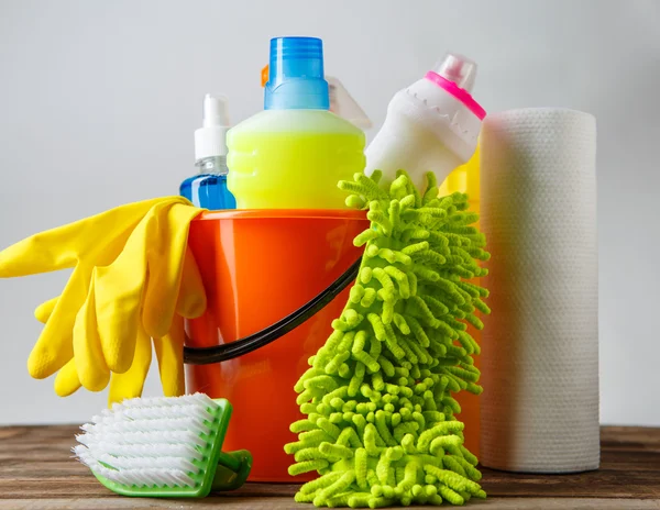 Bucket with cleaning items on light background — Stock Photo, Image
