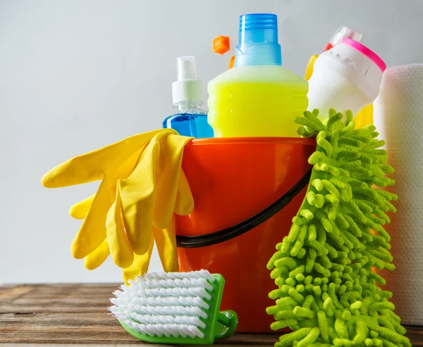 Bucket with cleaning items on light background — Stock Photo, Image