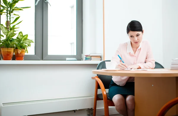 Wonam work with papers in office room. Stock Photo