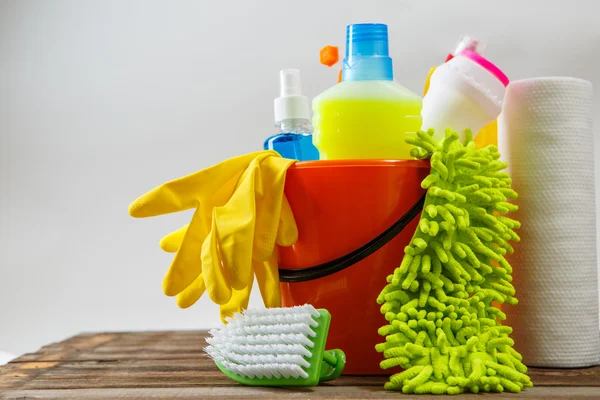 Bucket with cleaning items on light background — Stock Photo, Image