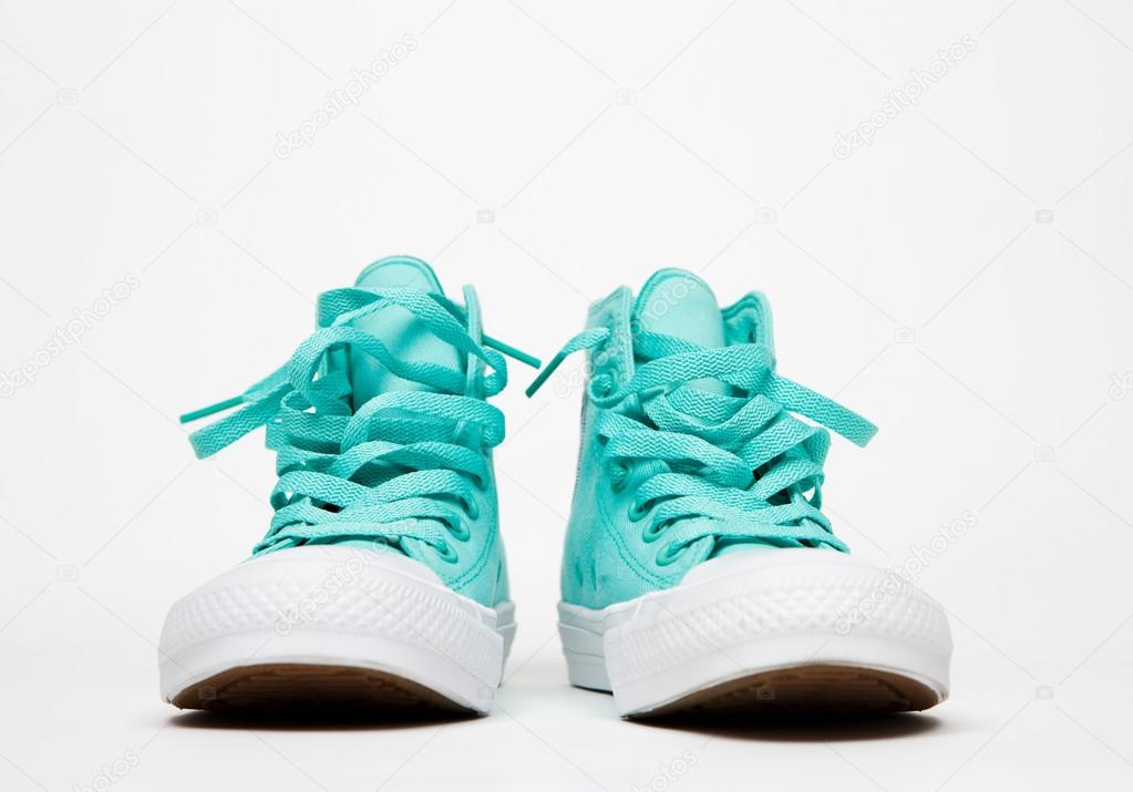 Classic sneakers with laces on white rubber sole on white background