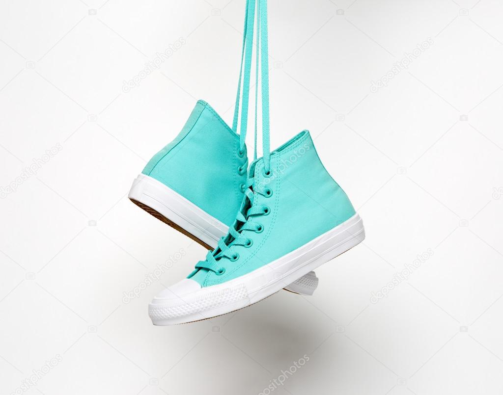 Blue shoes suspended for laces isolated on white background
