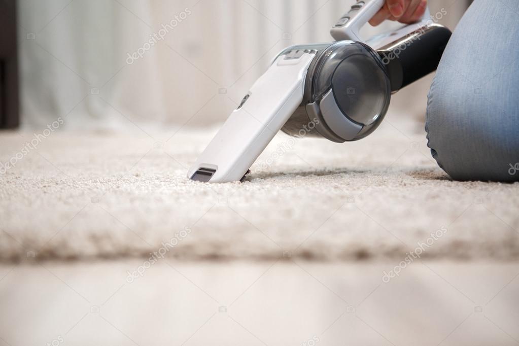Process of cleaning carpet with help portable vacuum cleaner