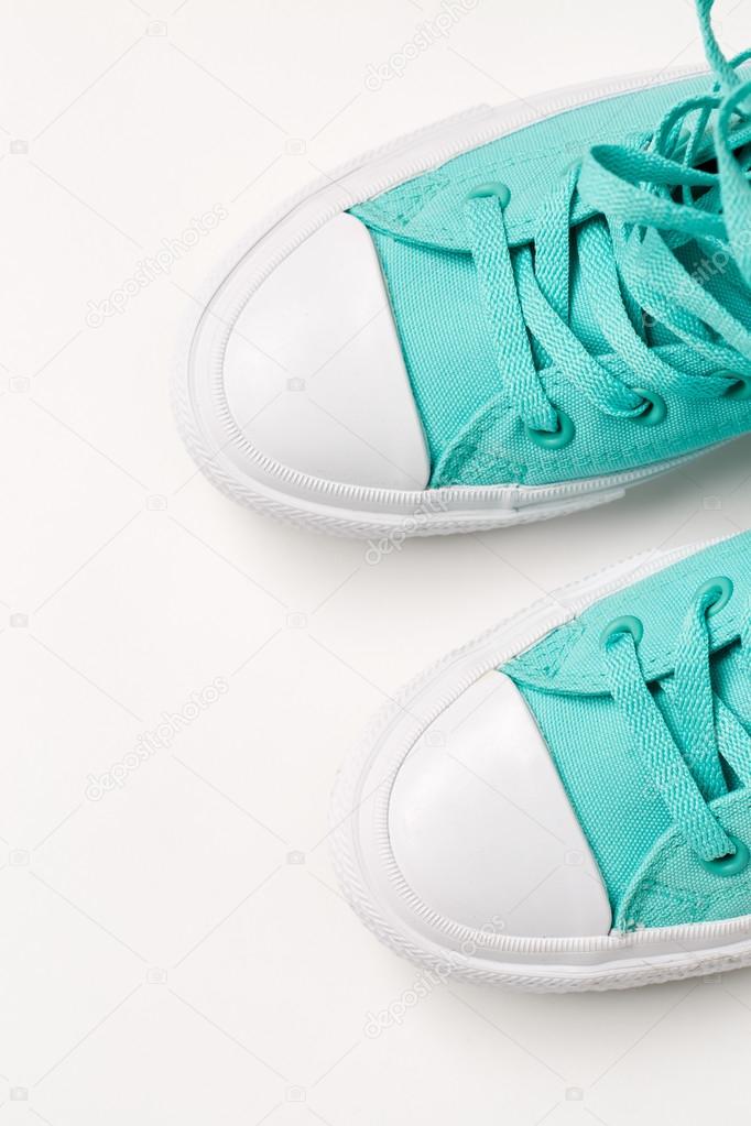 Top view of blue sneakers on white background.