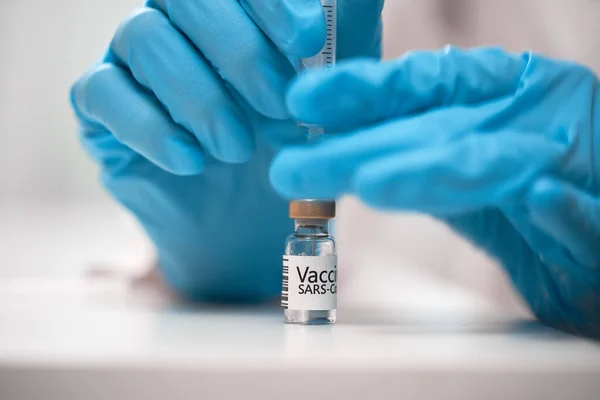 Доктор набирает вакцину в шприц — стоковое фото