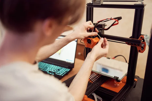 Молодой человек установил 3D принтер — стоковое фото