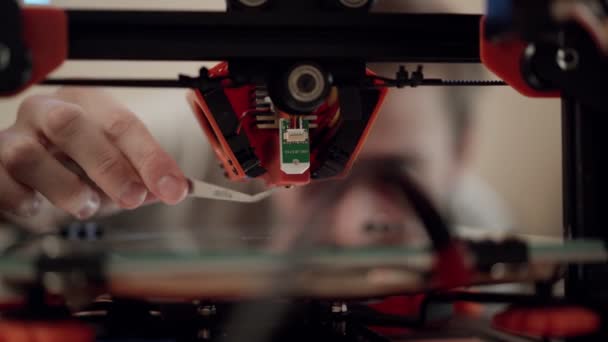 Técnico que realiza mantenimiento de impresora 3D — Vídeo de stock
