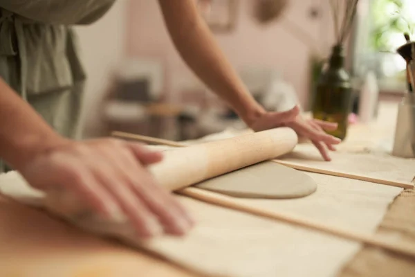 Vrouwelijke pottenbakker rollen klei plaat — Stockfoto