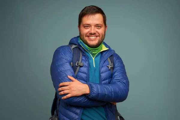 Portrait of man backpacker over blue — Stock Photo, Image