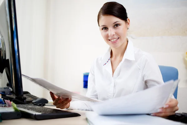 Beautiful business woman looking at papers Royalty Free Stock Photos