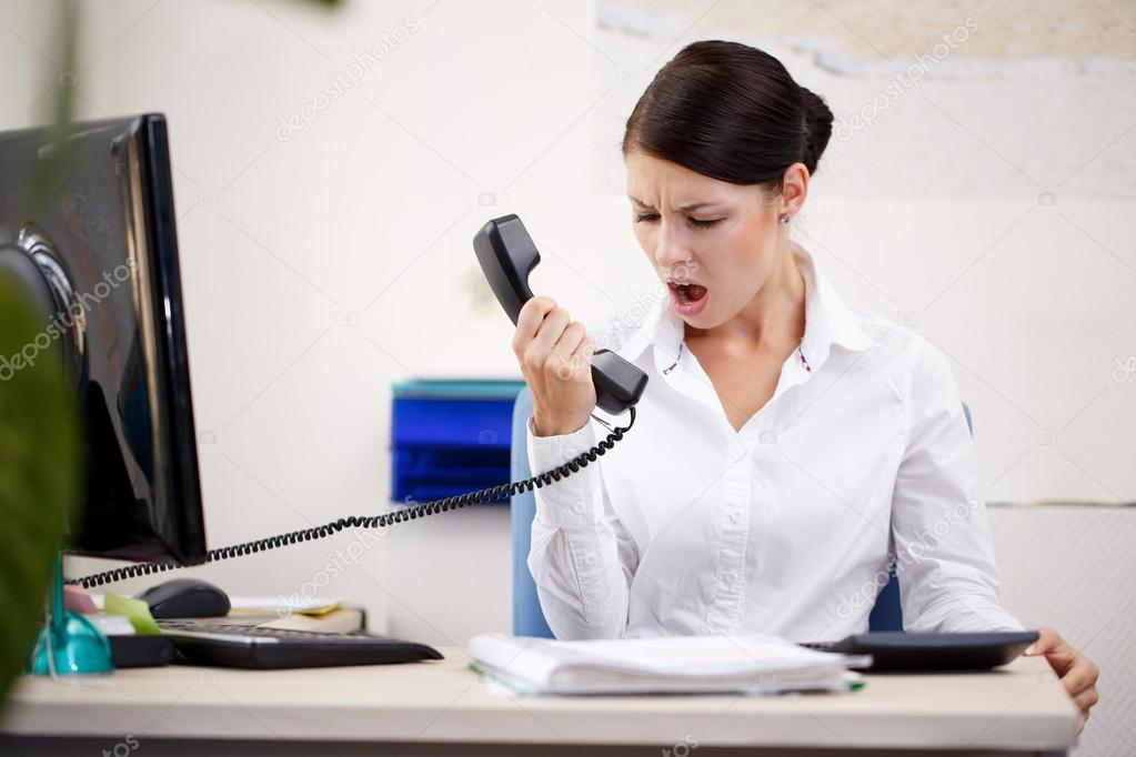 Angry woman shouting at phone