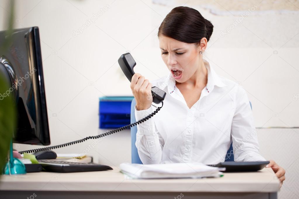 Angry woman shouting at phone