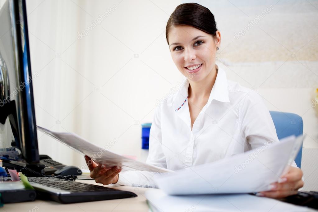 Beautiful business woman looking at papers
