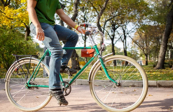 Nahaufnahme eines jungen Mannes, der im Park Fahrrad fährt — Stockfoto