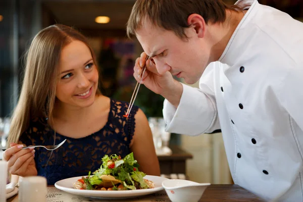 Chef decorating  salad. — Stock Photo, Image