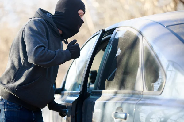 Thief stealing automobile car at daylight street in city — Stock Photo, Image